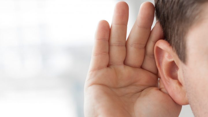 Hand cupped behind ear